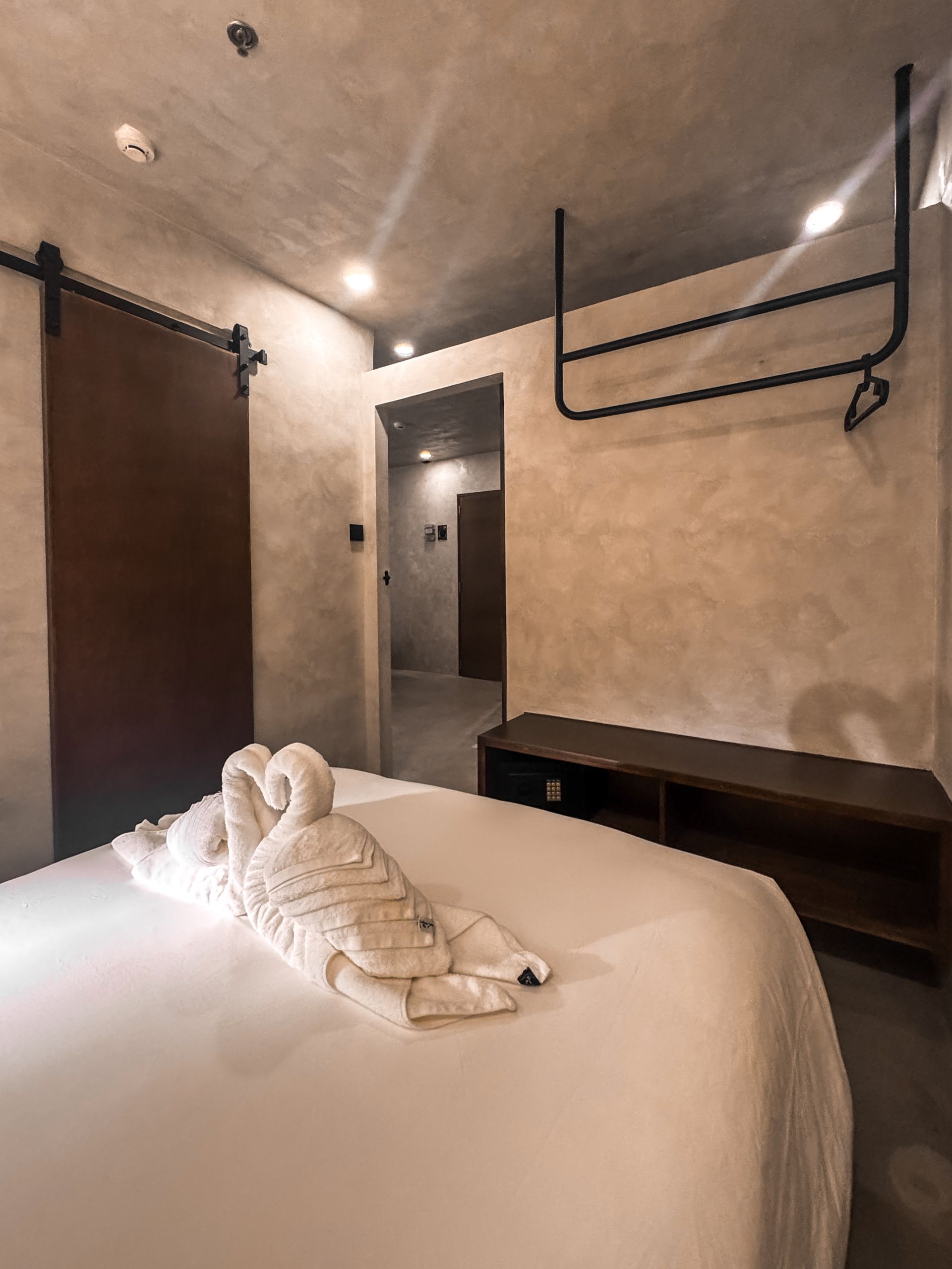 A bedroom with a bed and a sliding barn door.