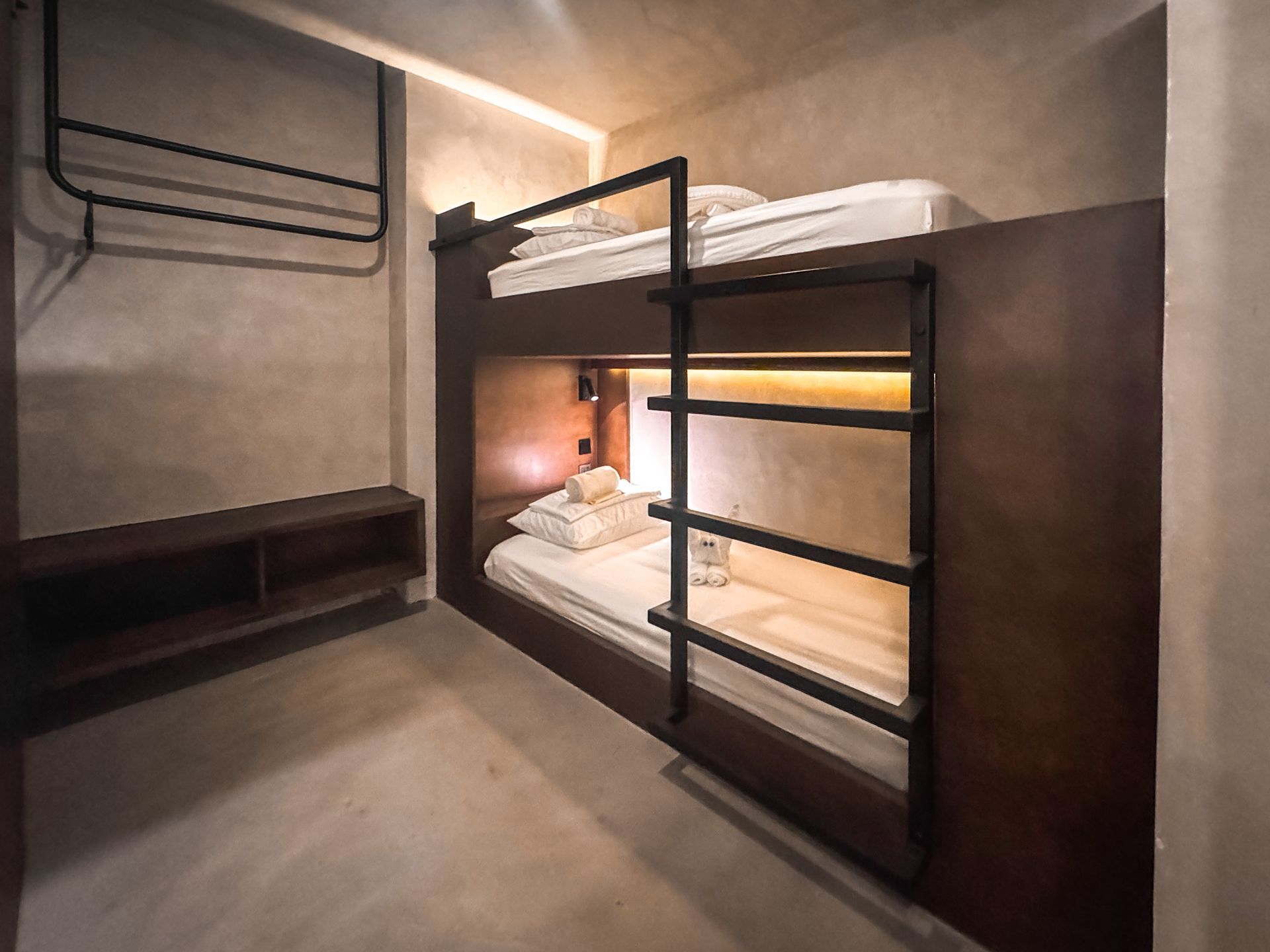 A bunk bed in a room with a ladder leading to it