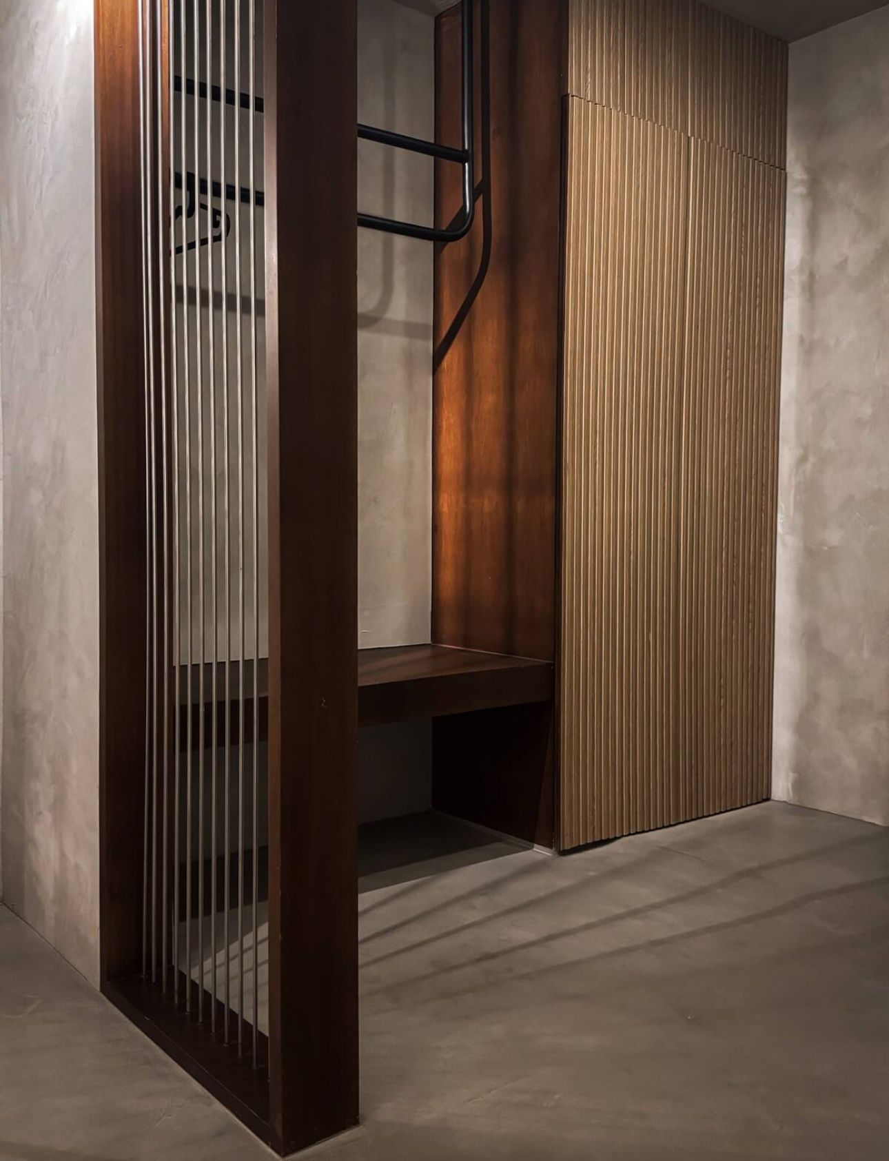 A room with a wooden divider and a bench