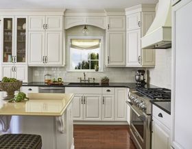 Transitional white kitchen with quartz countertops.  