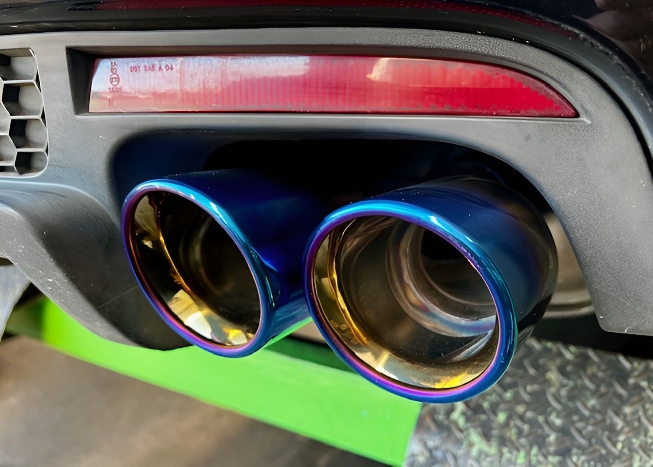 Close-up of a Car's Dual Exhaust Pipe — Gladstone Mufflers & Suspension In Gladstone Central, QLD