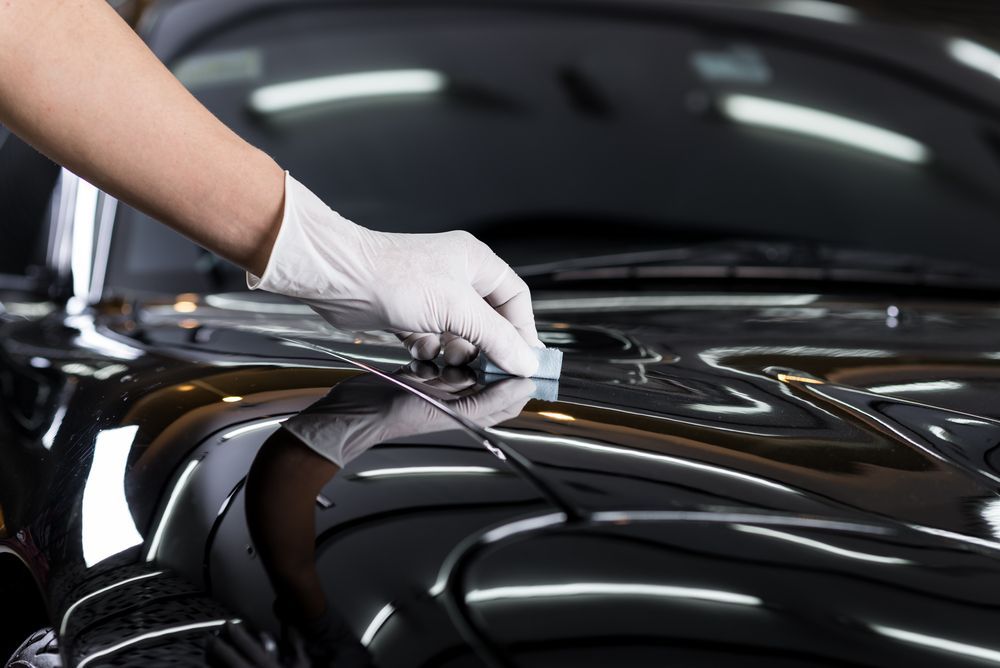 Gloved Hand Applying a Coating — Gladstone Mufflers & Suspension In Gladstone Central, QLD