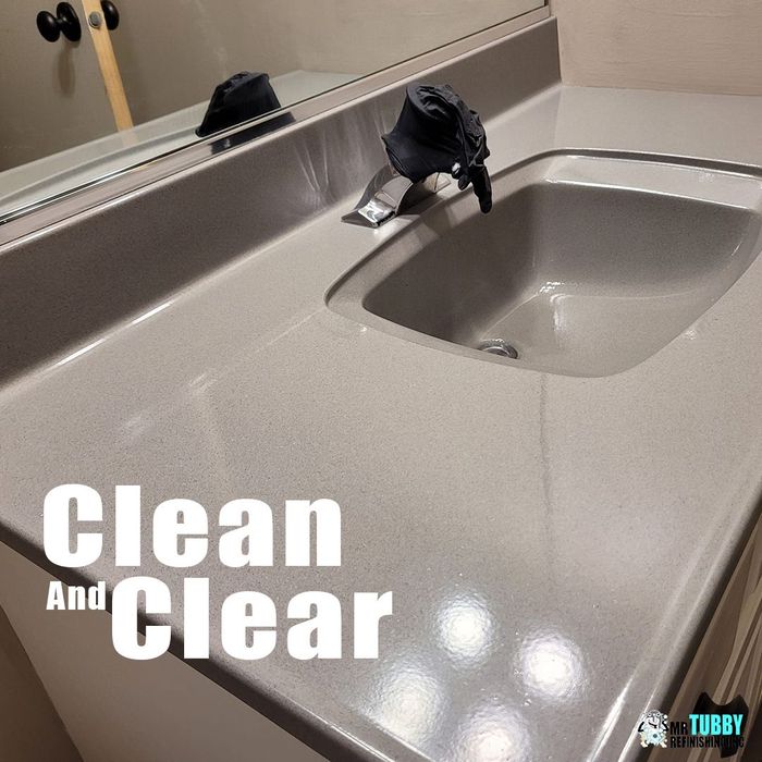 Image of a bathroom taped up as preparation for the bathtub refinishing. 