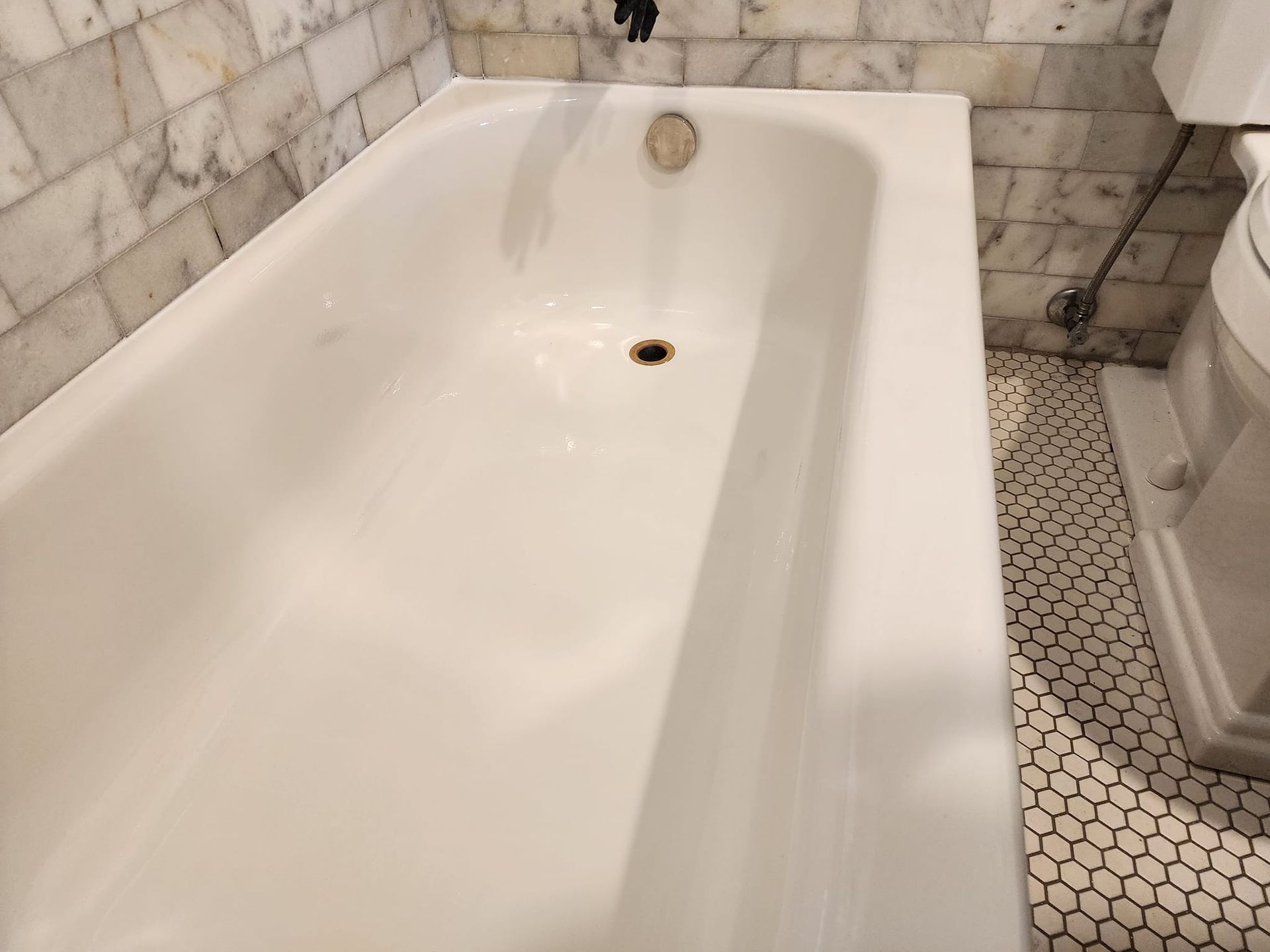 Image of a bathtub that just got refinished. You can see the new glaze is nice and clean. 