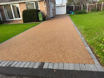 A block paving driveway with gravel and bricks leading to a house in Rochdale.