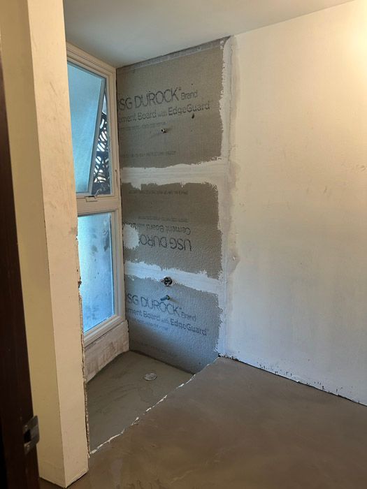 A room with a window and a door is being remodeled.