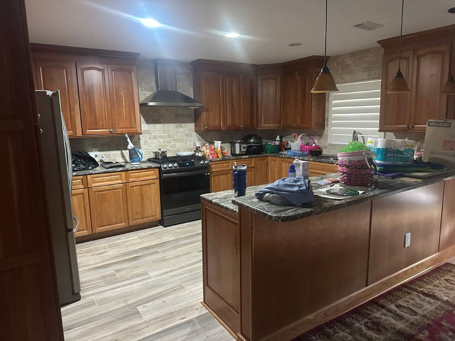 A kitchen with wooden cabinets and granite counter tops.