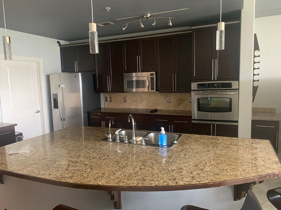 A kitchen with granite counter tops and stainless steel appliances