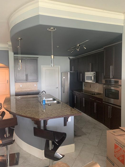 A kitchen with a home depot box on the floor