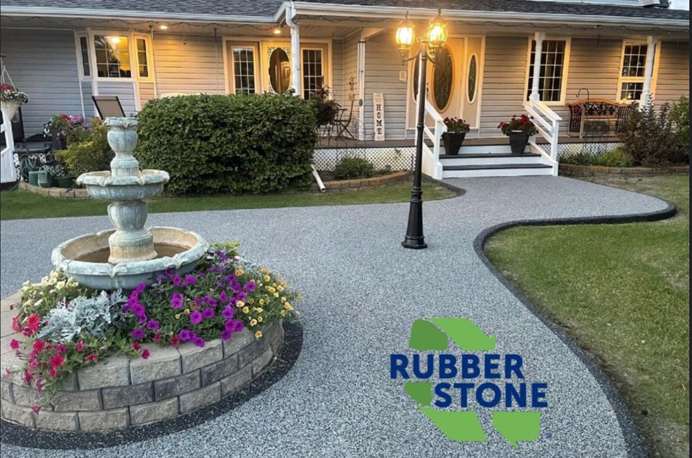 A house with a fountain in front of it and a sign that says rubber stone