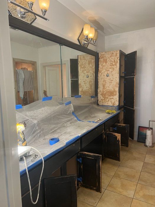 A bathroom with a lot of cabinets and a large mirror