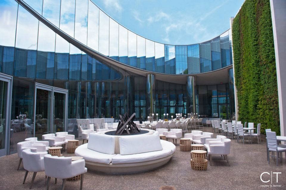 A large building with a lot of chairs and tables in front of it