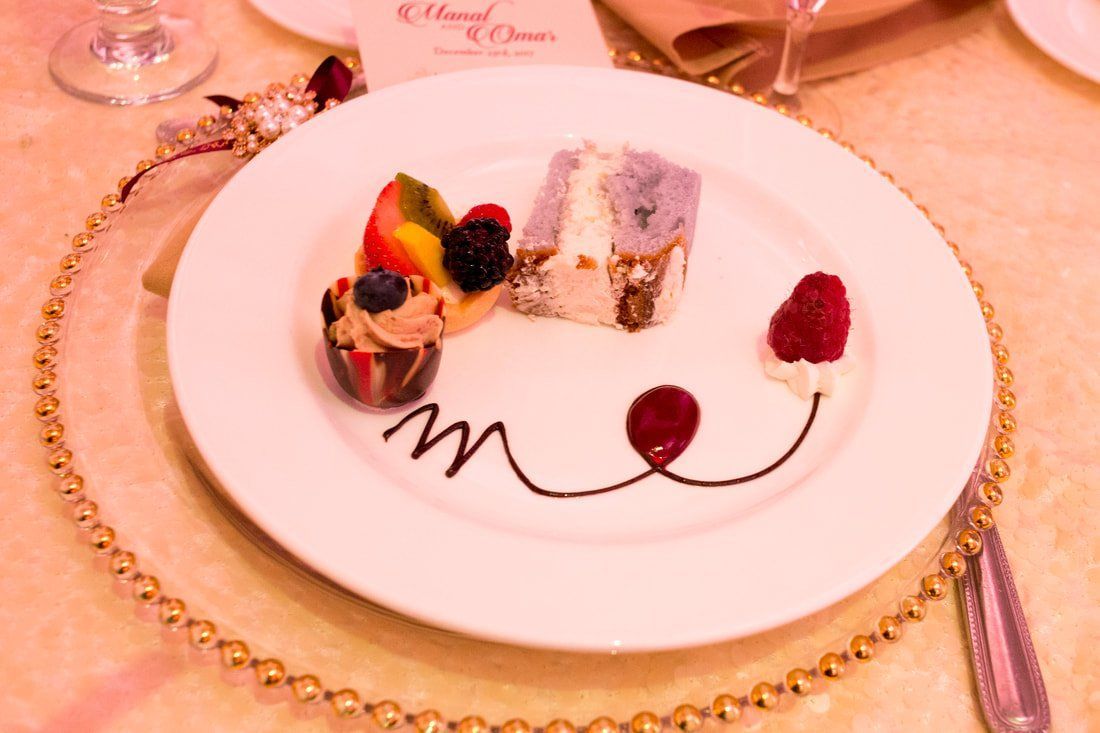 A white plate with a dessert on it with a m on it