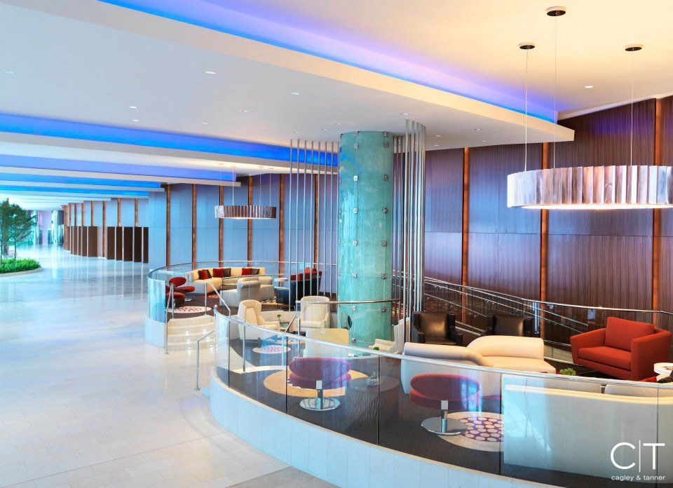 A large lobby with a curved counter and a lot of furniture.
