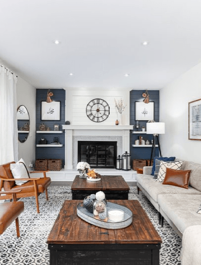 A living room with a couch , chairs , coffee table and fireplace.