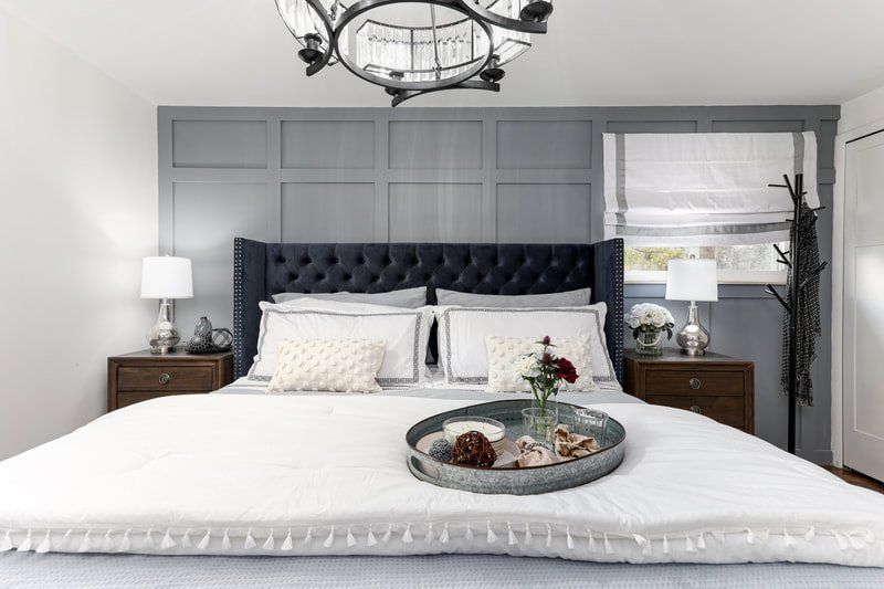 There is a tray on the bed in the bedroom.