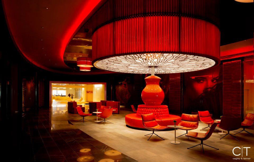 A large red lamp is hanging from the ceiling of a room
