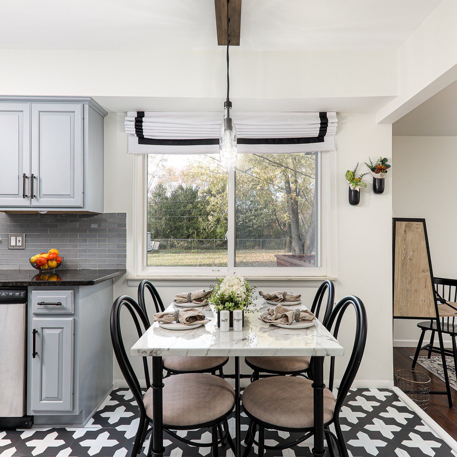 A kitchen with a table and chairs and a window