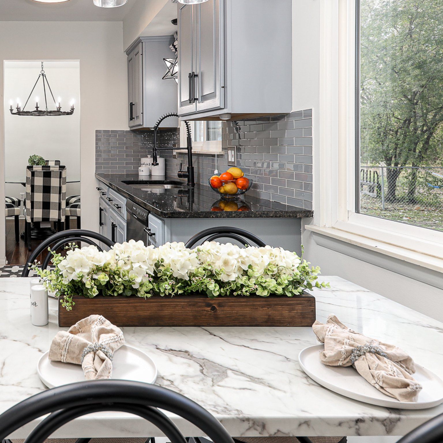A kitchen with a table and chairs and a window