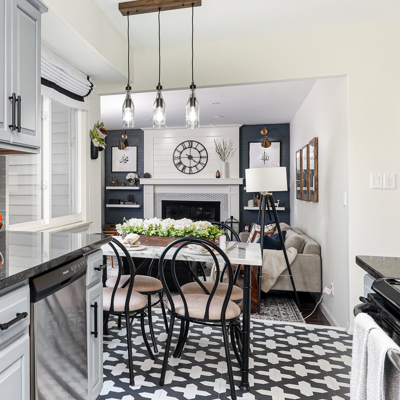 A kitchen with a table and chairs and a clock on the wall