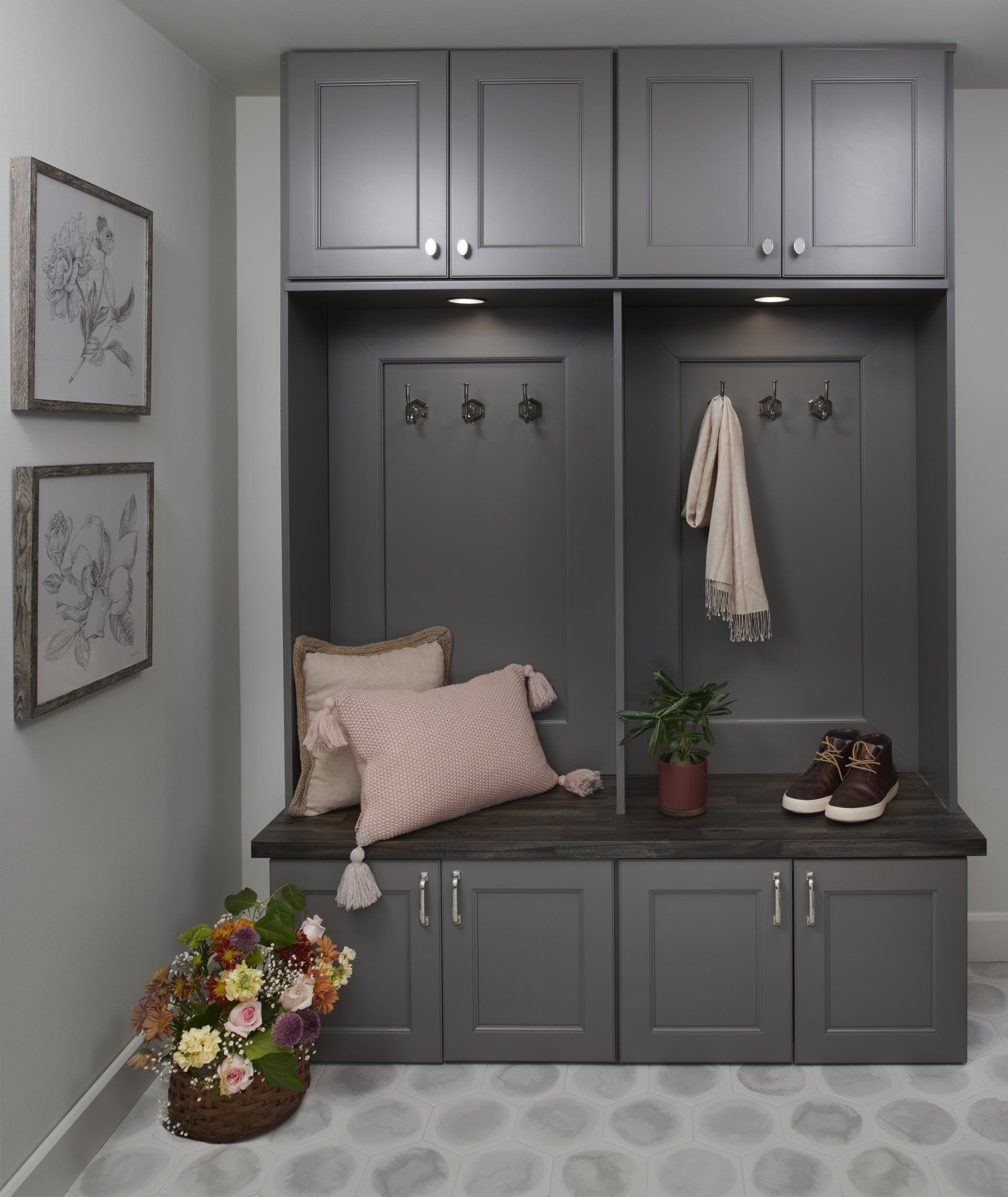 A corner of a room with a bench and a basket of flowers