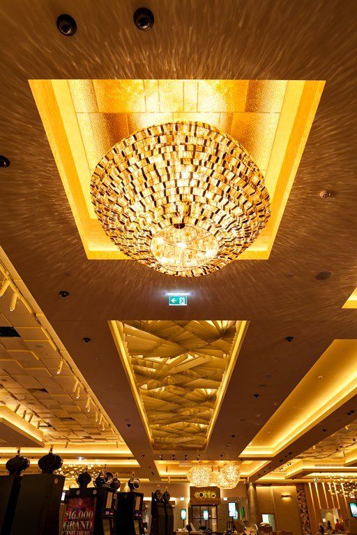 A large chandelier is hanging from the ceiling of a large room.