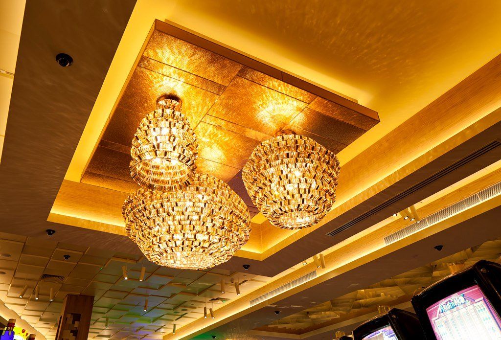 A large chandelier hangs from the ceiling of a casino
