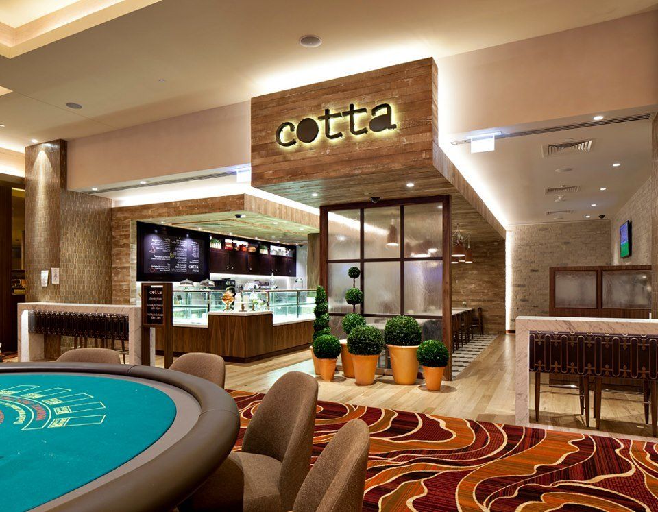 A casino with a table and chairs and a sign that says cotta