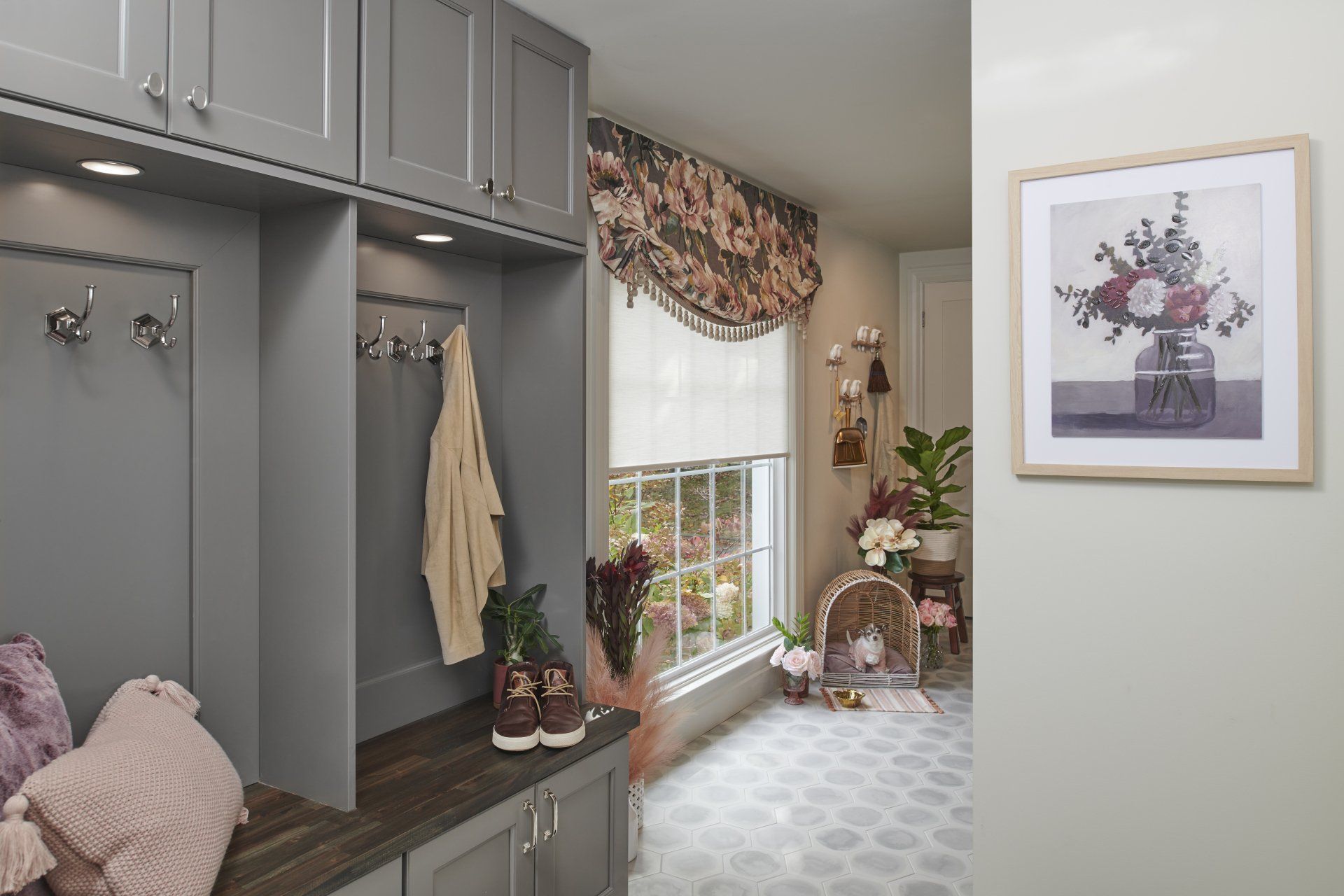 There is a picture of a vase of flowers on the wall.