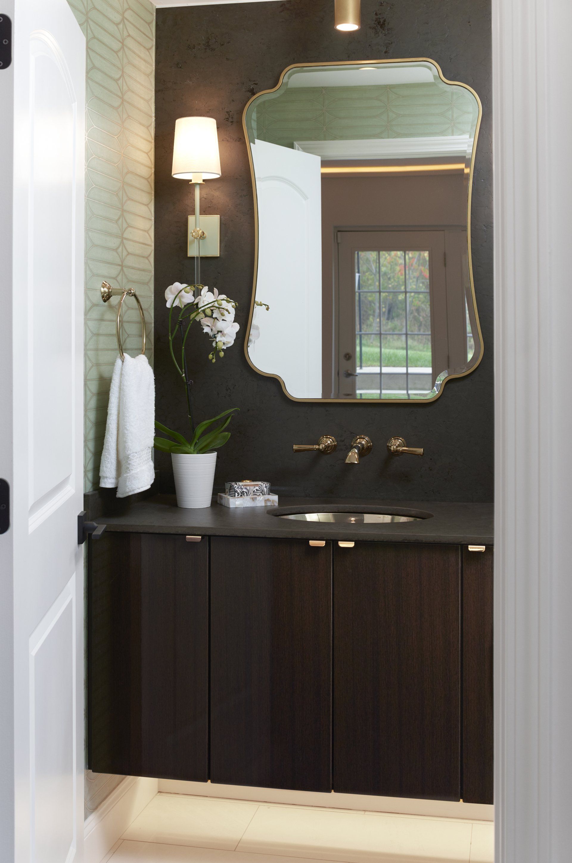 A bathroom with a sink and a mirror on the wall.