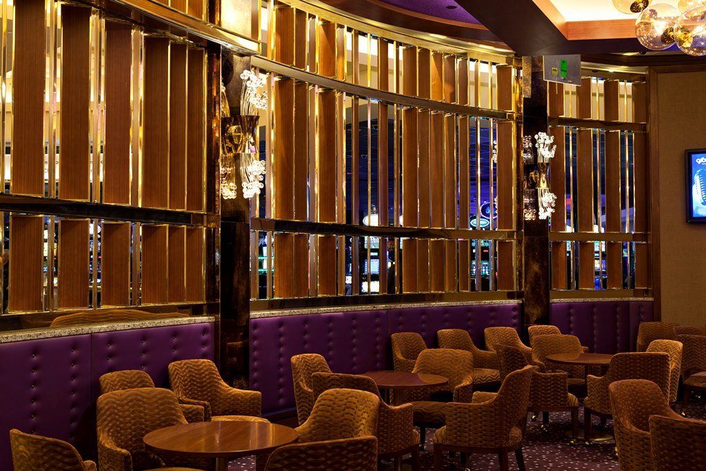 A dining room with tables and chairs and a television