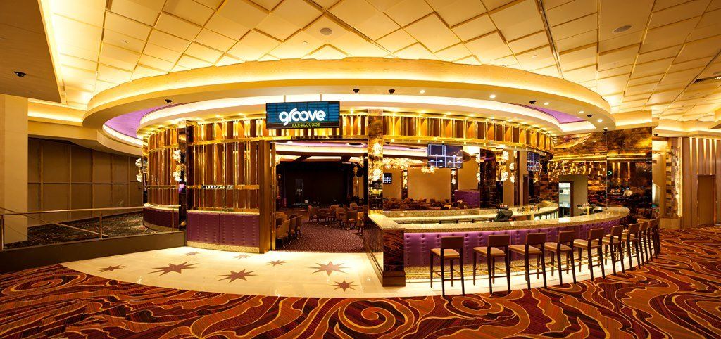 A large room with a circular bar in the middle of it.