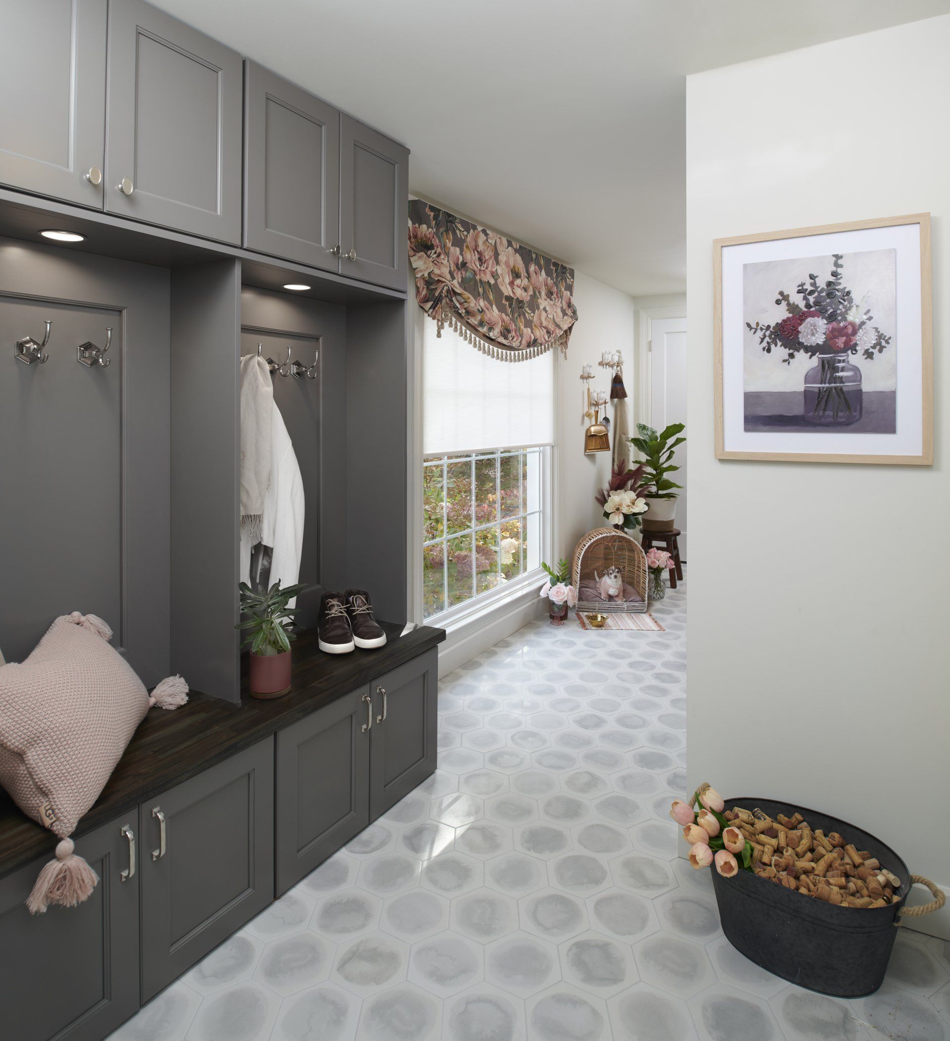 A hallway with a picture of a vase of flowers on the wall.