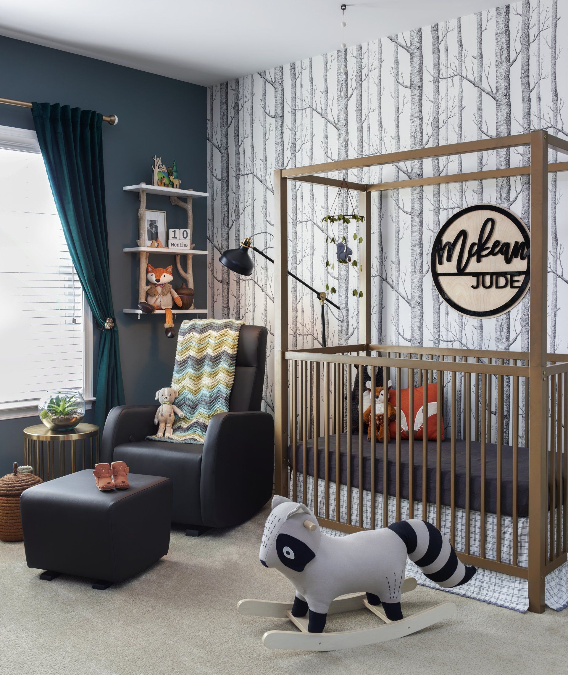 A nursery with a crib , rocking horse , chair and ottoman.