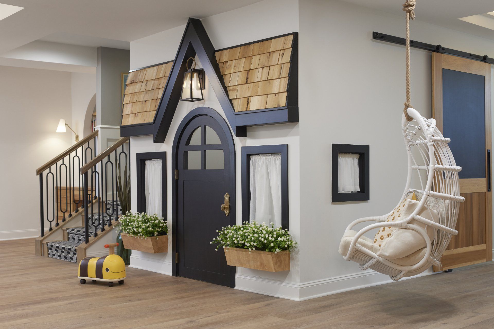 There is a playhouse in the corner of the room.