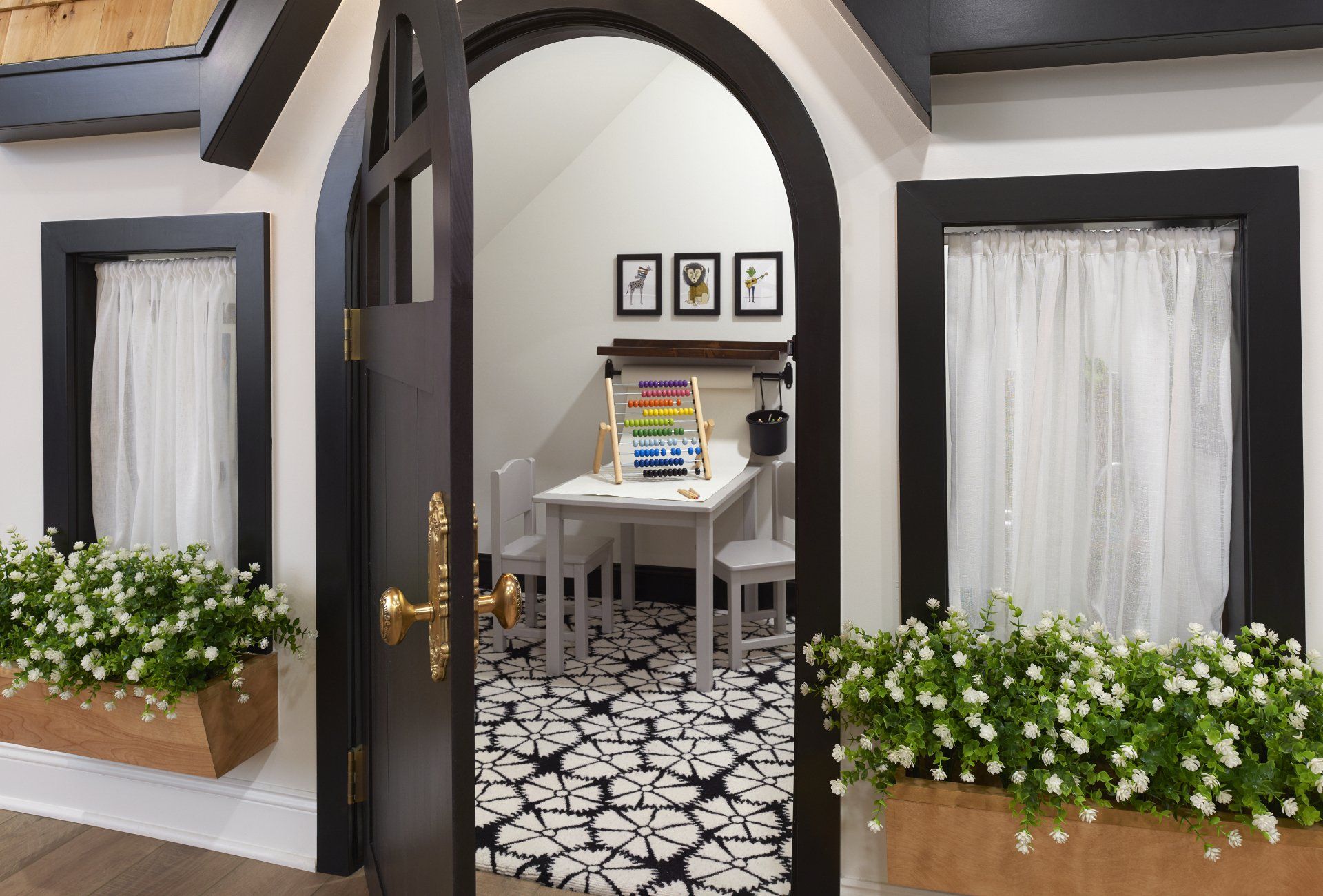 A playhouse with a table and chairs inside of it.