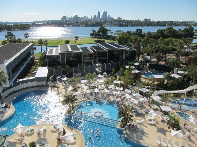 An aerial view of a large swimming pool surrounded by chairs and umbrellas