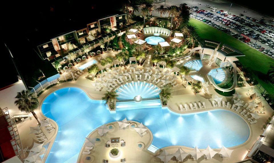 An aerial view of a large swimming pool at night.