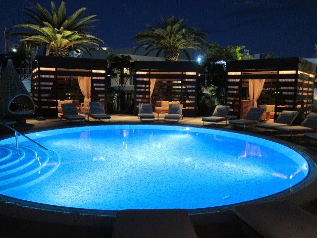 A large swimming pool is lit up at night