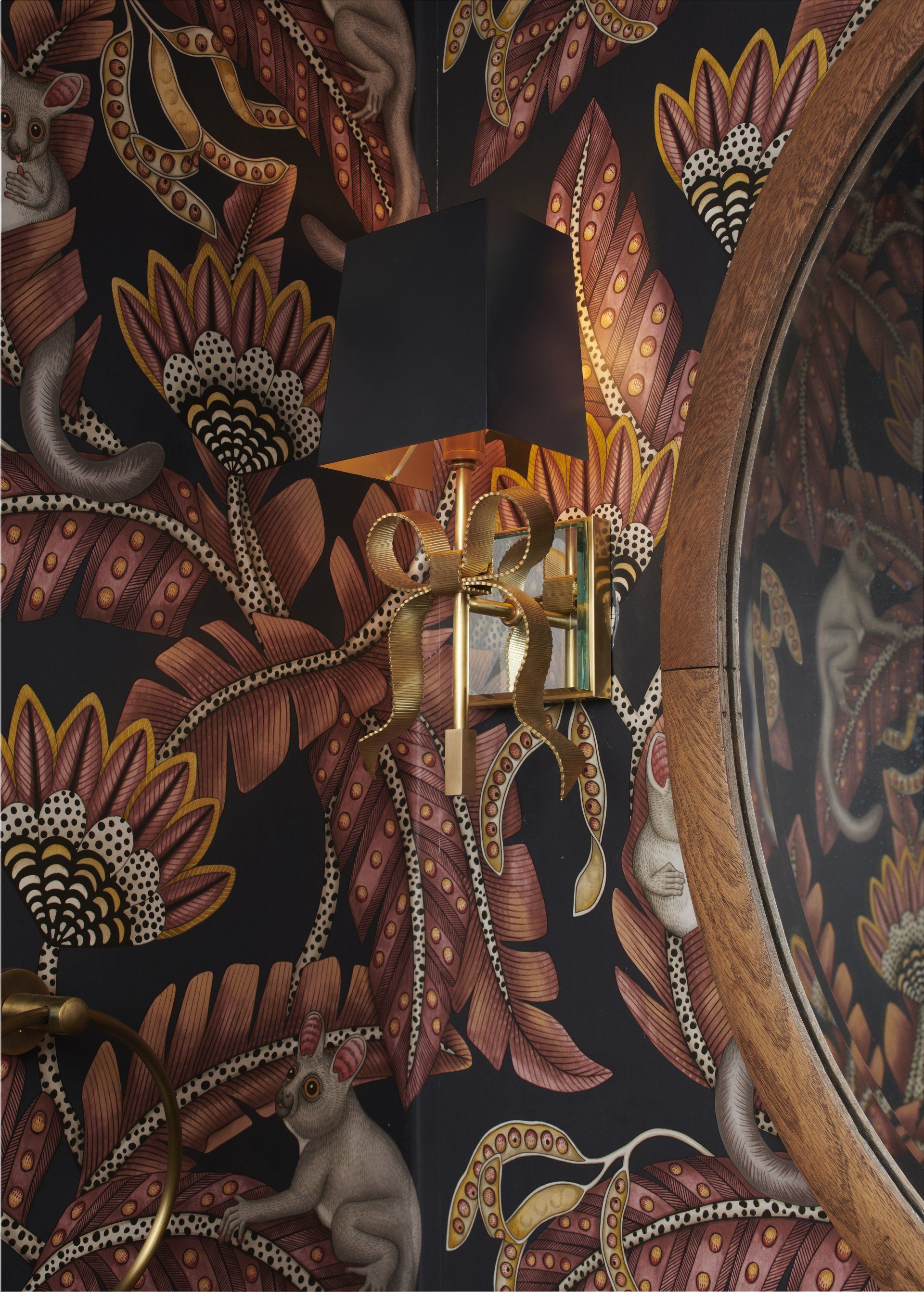 A wall with a lamp and a mirror on it