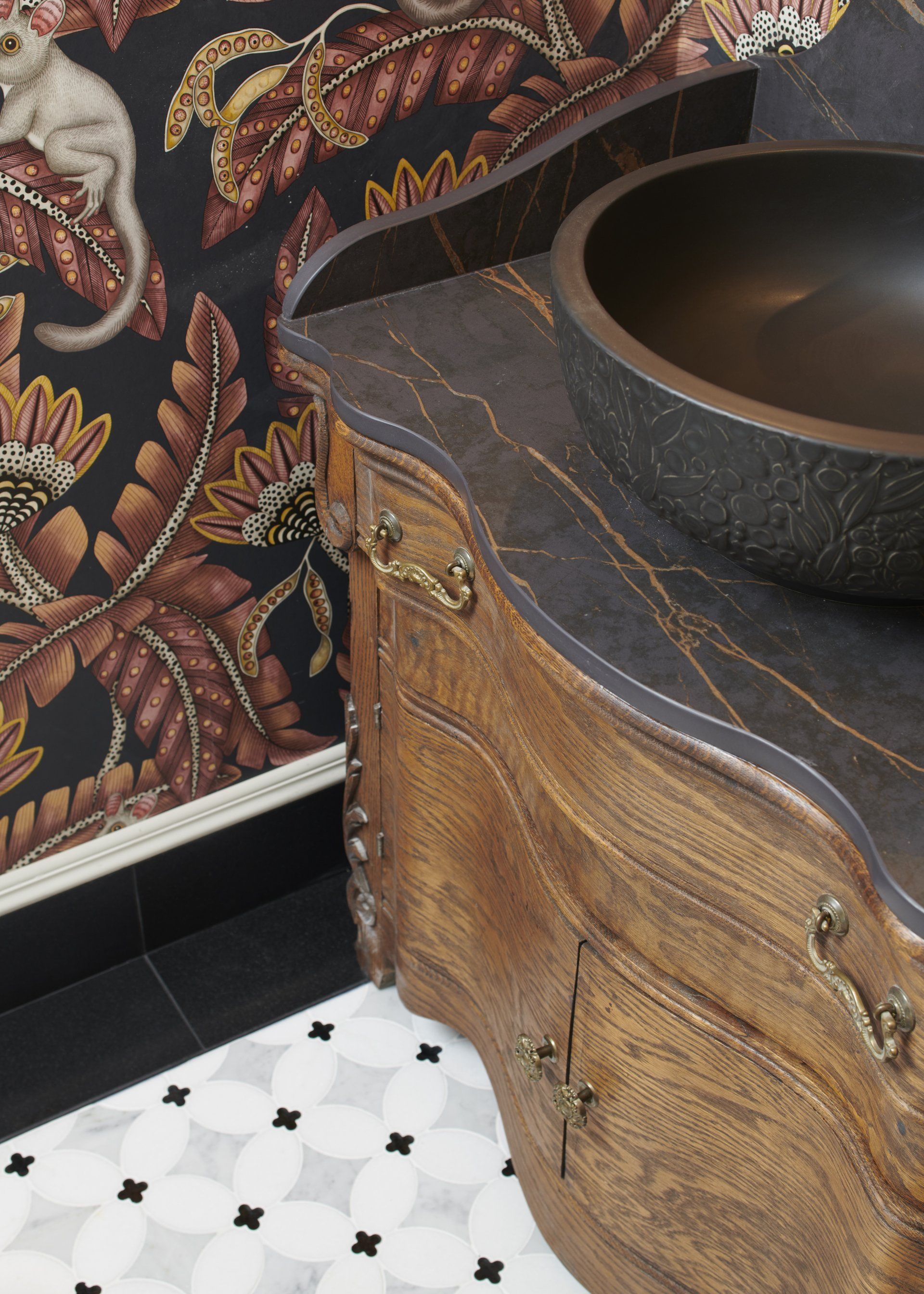 A bathroom with a wooden vanity and a sink