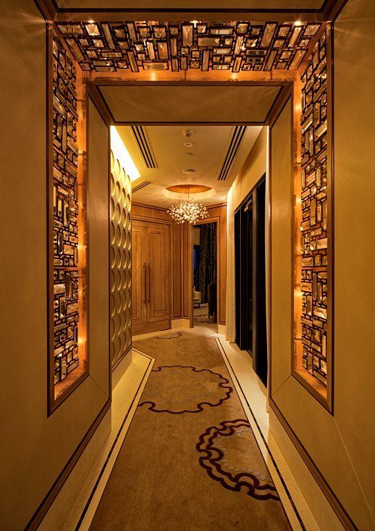 A long hallway with a chandelier hanging from the ceiling
