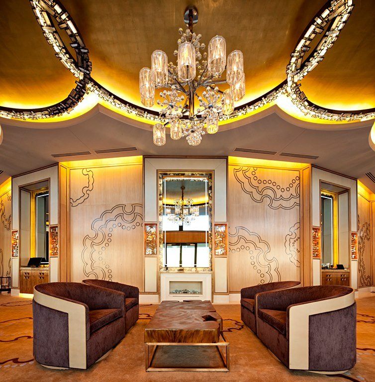 A living room with a chandelier hanging from the ceiling