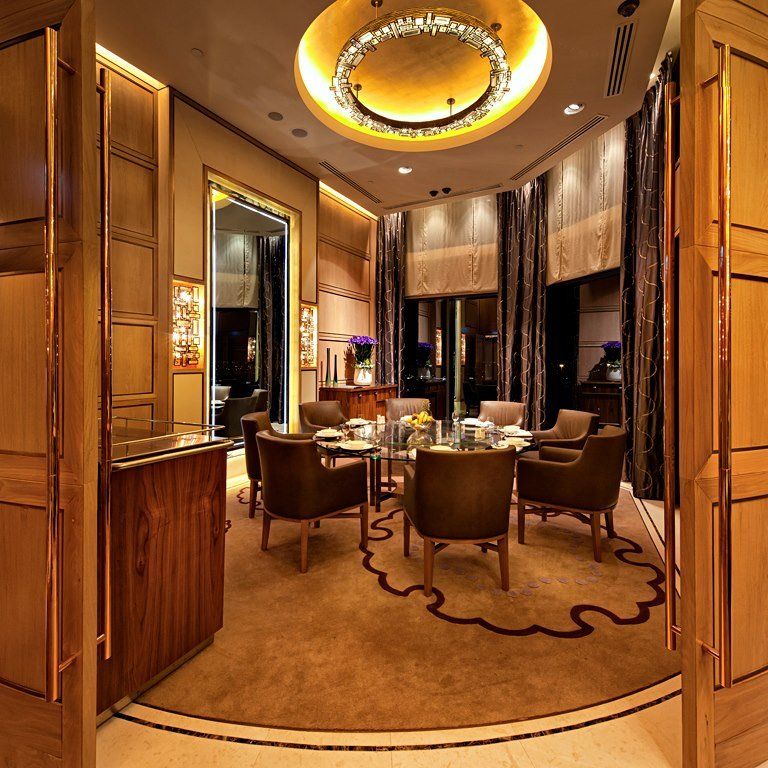 A dining room with a round table and chairs