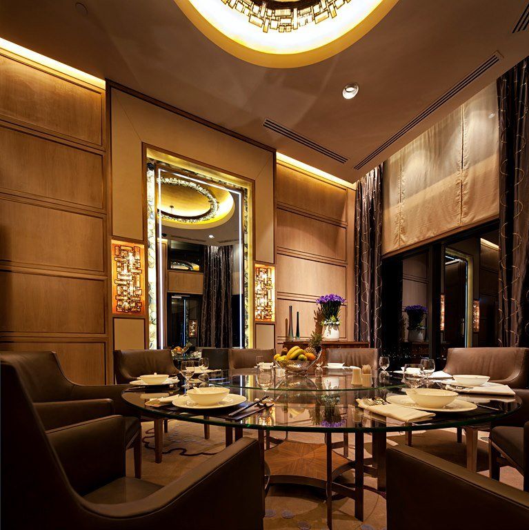 A dining room with a glass table and chairs