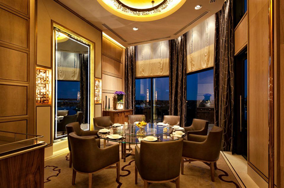 A dining room with a round table and chairs