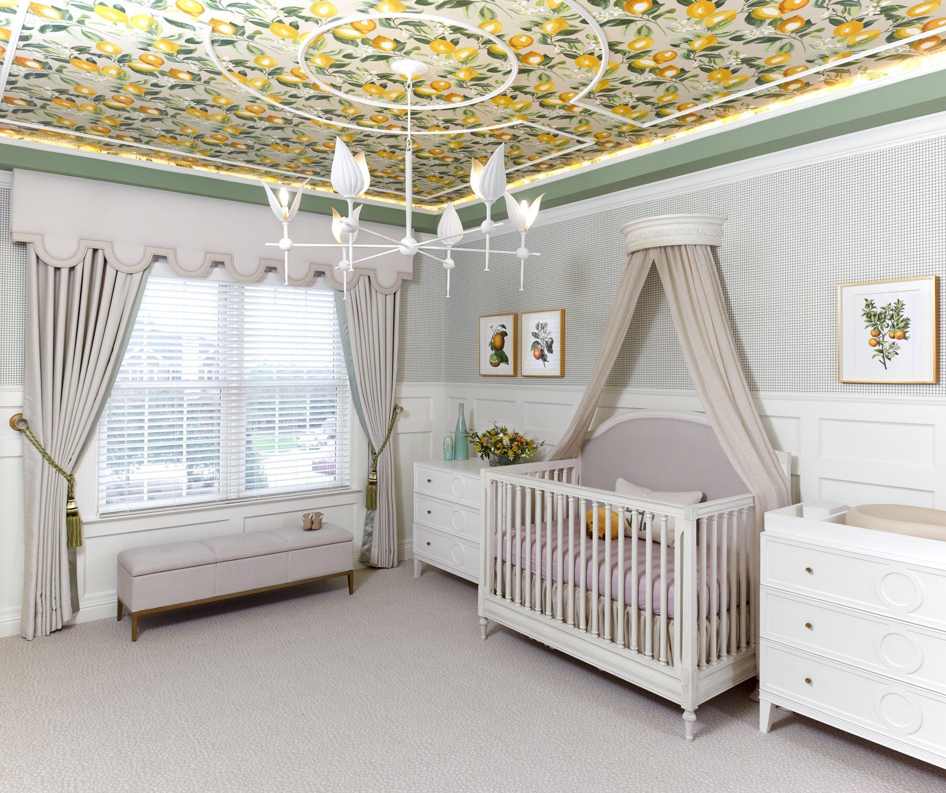 A nursery with a crib , dresser , bench and chandelier.