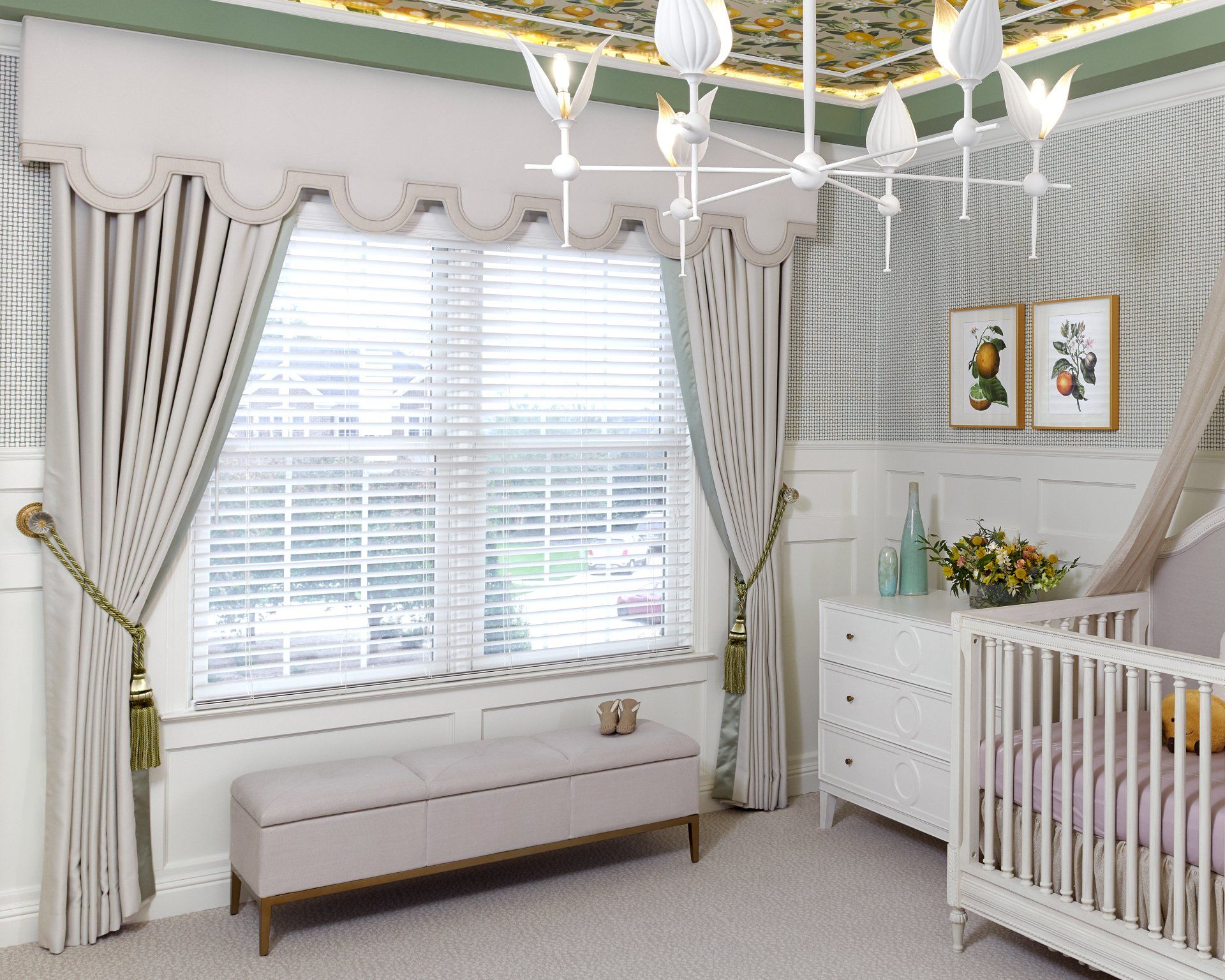 A baby room with a crib , dresser , bench and window.