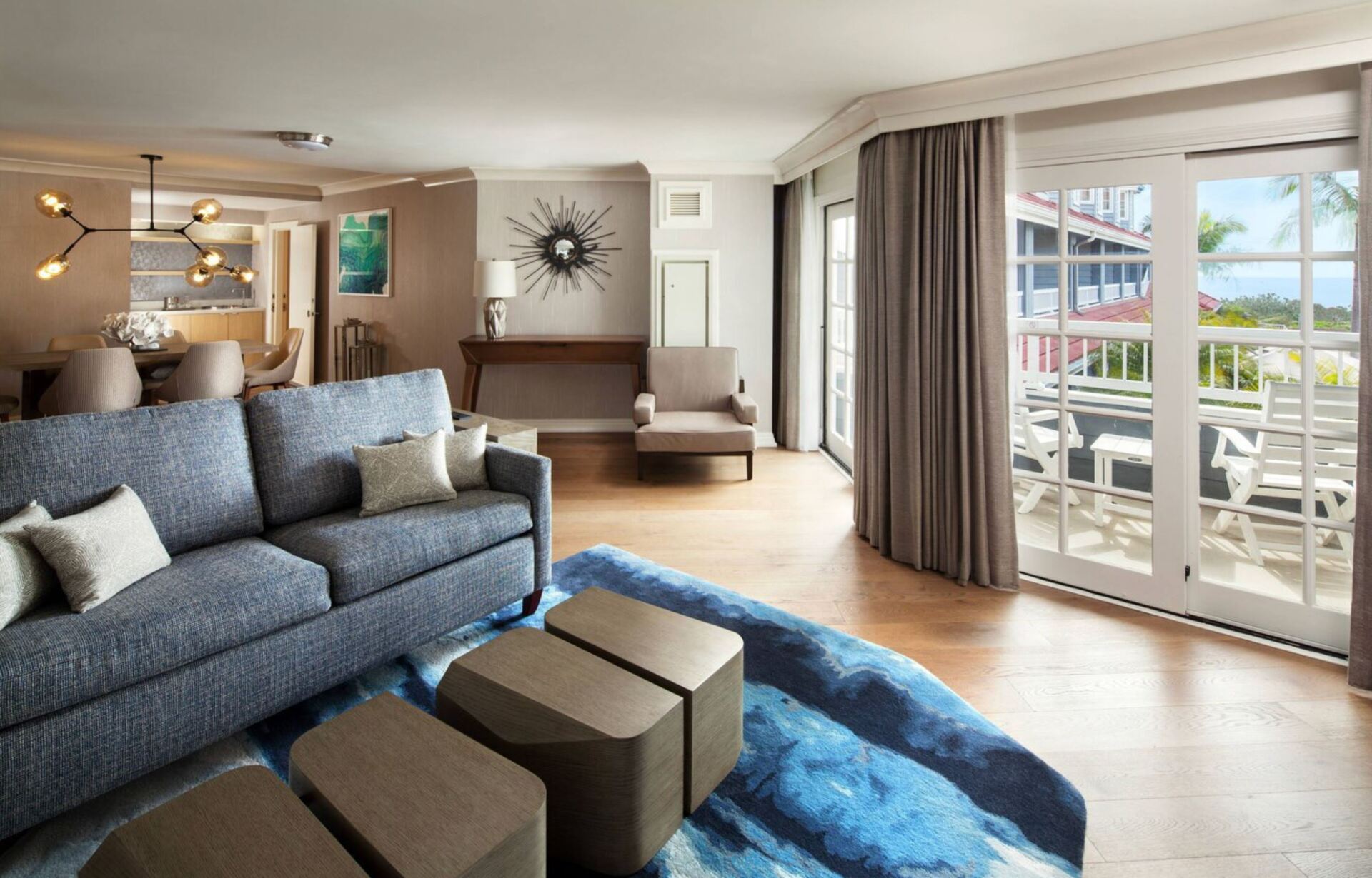 A living room with a blue couch and a blue rug