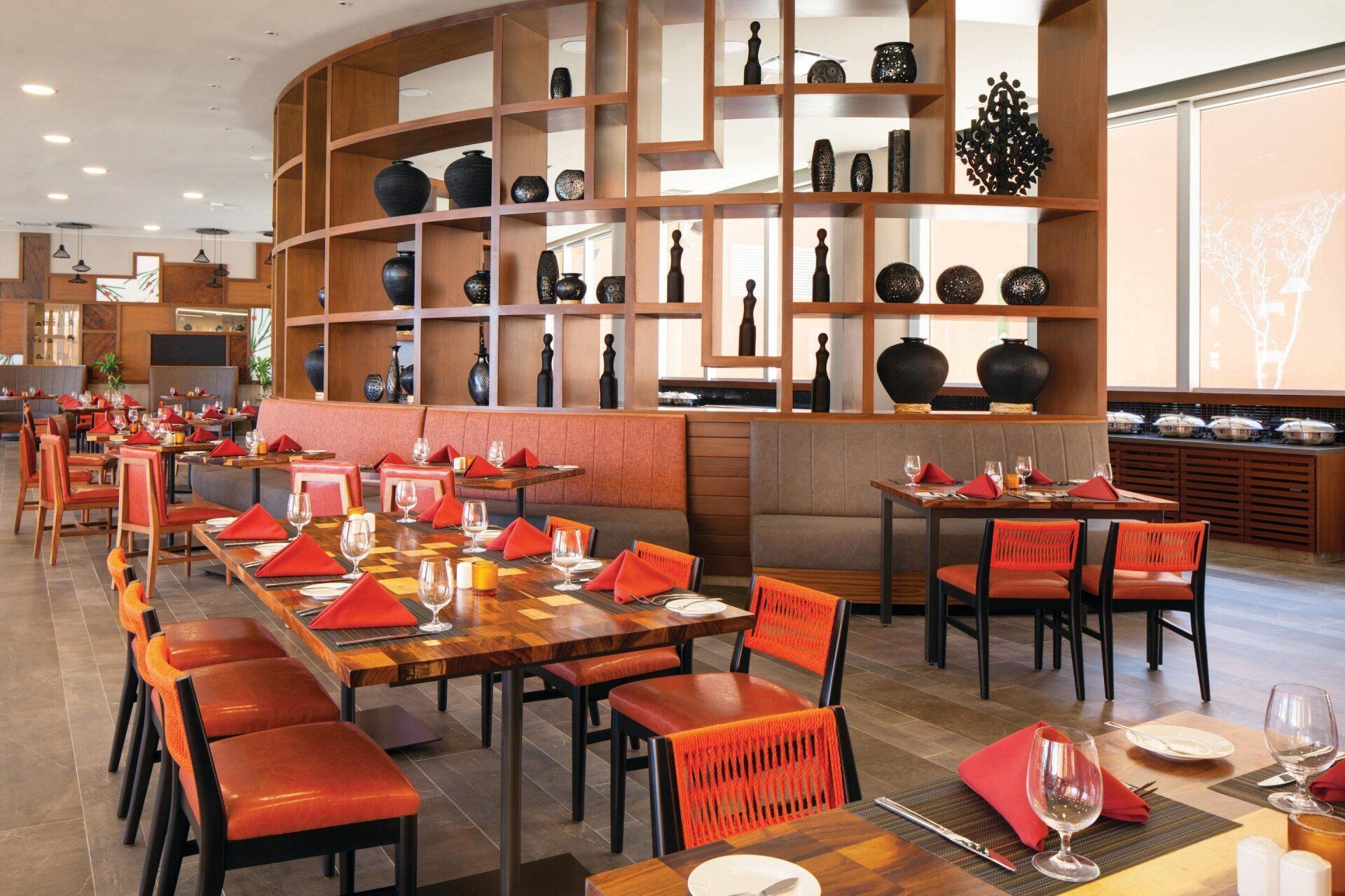 There are many tables and chairs in the restaurant.